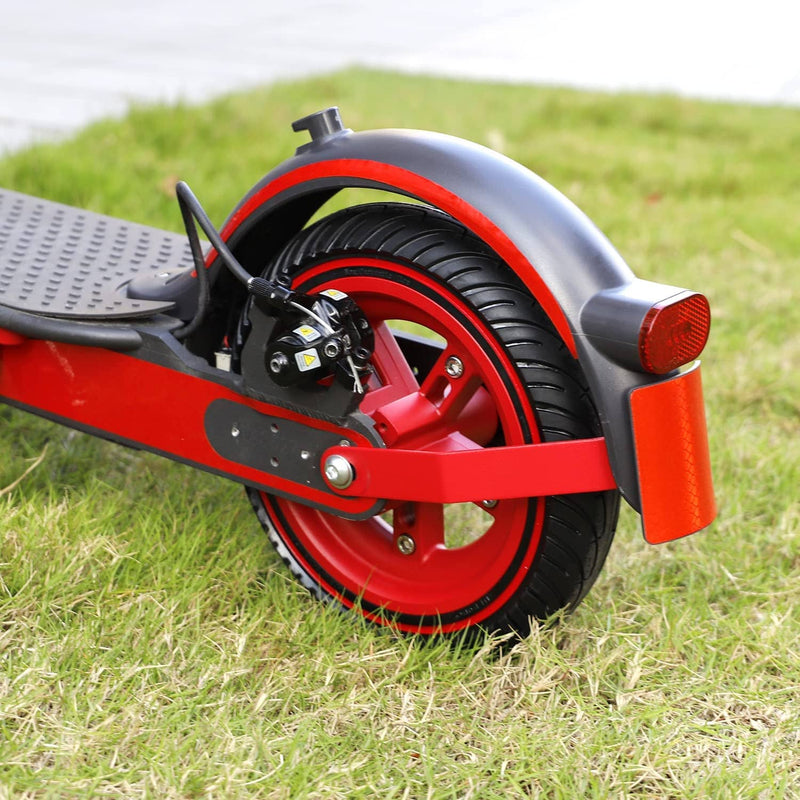 Chargez l'image dans la visionneuse de la galerie, Close-up of red electric scooter rear wheel with disc brake and fender on grass